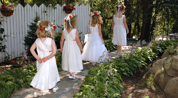 4 flower girls walking down aisle