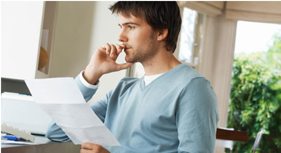 thoughtful groom reviewing and reading wedding vows